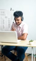 Teacher teaching students English language on video call at home: e-learning via interactive